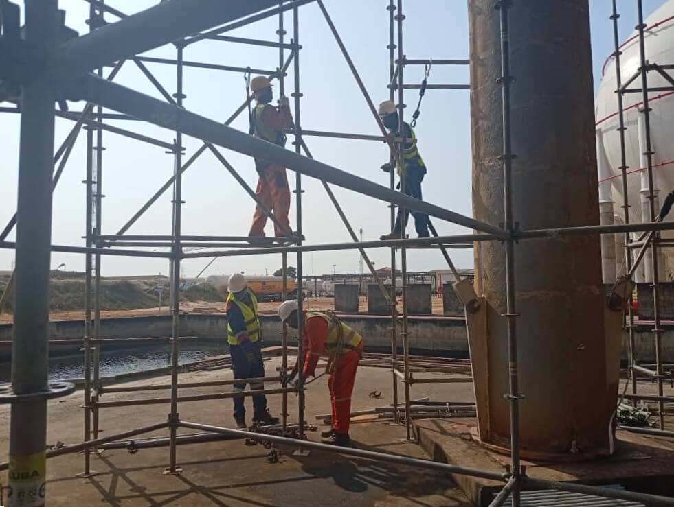 Scaffolders working on industrial tank maintenance.